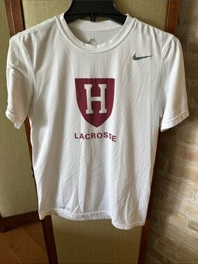 Nike Drifit size small White Tee with Maroon Harvard Shield Lacrosse Logo